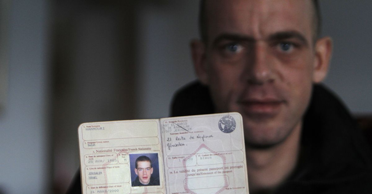 Hamouri shows his French passport during an interview with Reuters near Jerusalem