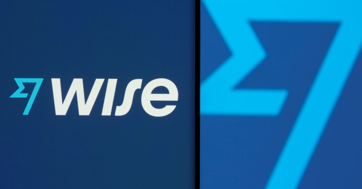 Wise logo is seen on a smartphone in front of a displayed detail of the same logo