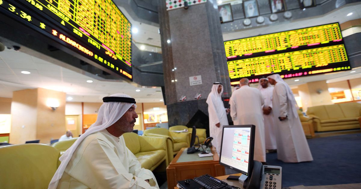 An investor monitors a screen displaying stock information at the Abu Dhabi Securities Exchange