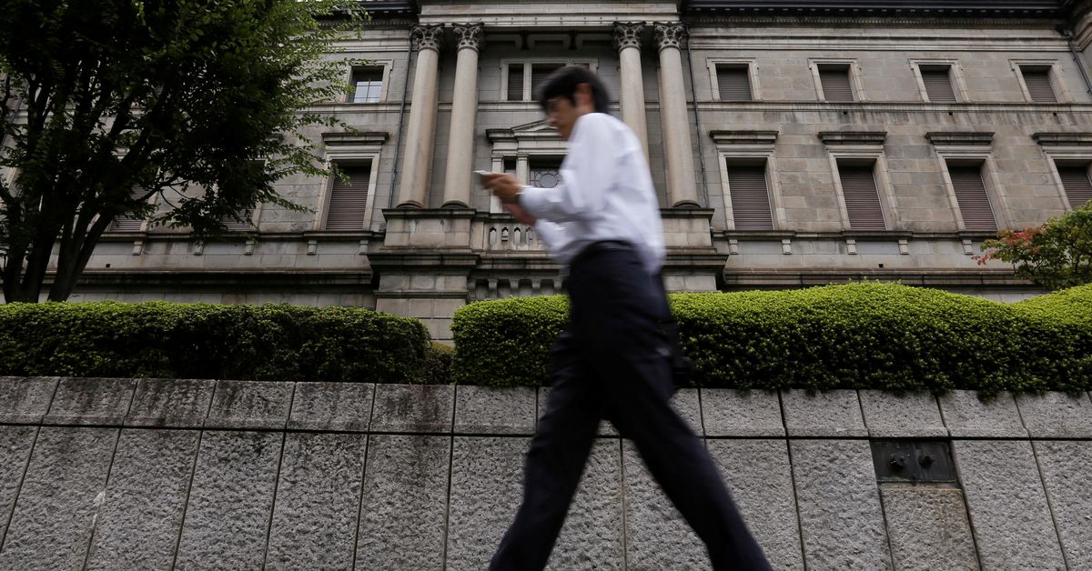 A businessman walks past the Bank of Japan (BOJ) building in Tokyo