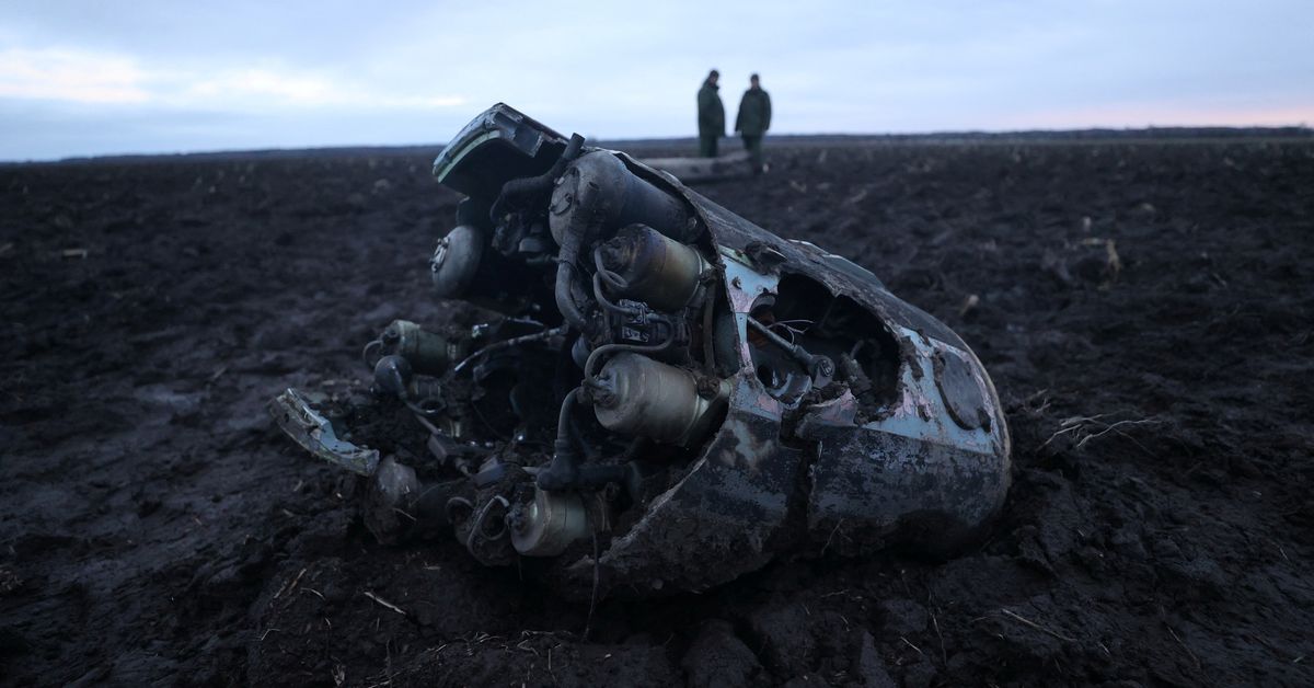 Investigators gather near fragments of a munition in the Grodno region