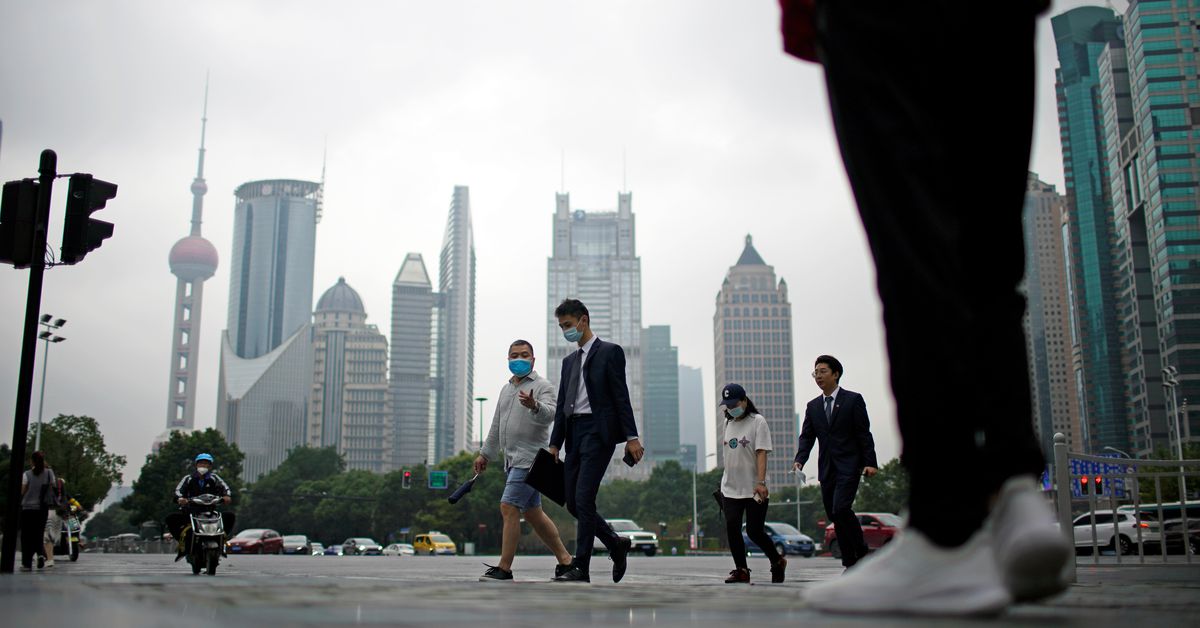 People walk along at financial district of Lujiazui in Shanghai