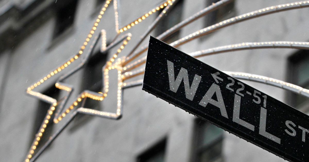 A holiday decoration is seen over Wall St. sign outside the New York Stock Exchange